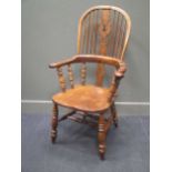 Circa 1840-1880 a broad arm Windsor high back elbow chair with fir tree fretted central splat