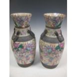 A pair of large Chinese vases, late 19th century, decorated with warriors, 47cm high