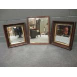 A pair of wooden framed mirrors with bevelled glass, together with one further mirror (3)