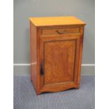 A French 19th century satinwood cabinet with single drawer over a single door and fret handle pull