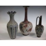 Three items of Royal Doulton stoneware to include, a vase, 35cm high, a bottle vase, 40cm high and a