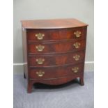 A George III flame mahogany bow front chest of four graduating long drawers on outswept bracket feet