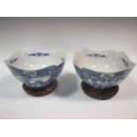 A pair of blue and white Chinese bowls, 24cm diameter on stands