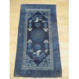 Three small Chinese blue and white patterned rugs