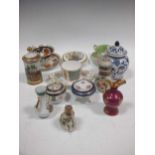 A collection of porcelain to include tea cups and saucers, a Shelley vase and floral encrusted