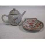 A small Chinese teapot and a small shell shaped dish