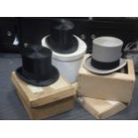 Two early 20th century top hats and a grey top hat, all boxed (3)