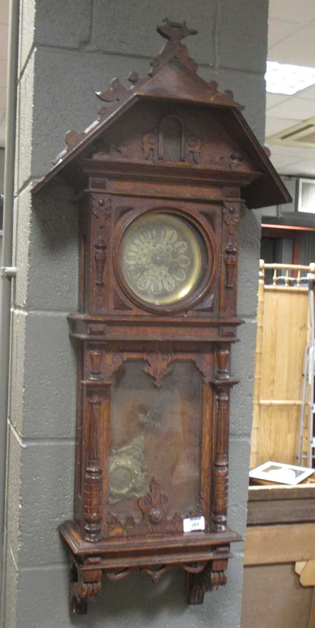 A late 19th century oak cased 8 day wall clock