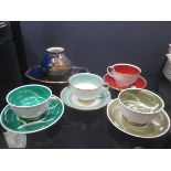 Four Susie Cooper tea cups and saucers, a Carlton ware vase and dish