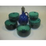 A Victorian blue glass decanter. A set of five emerald green glass finger bowls circa 1830. An