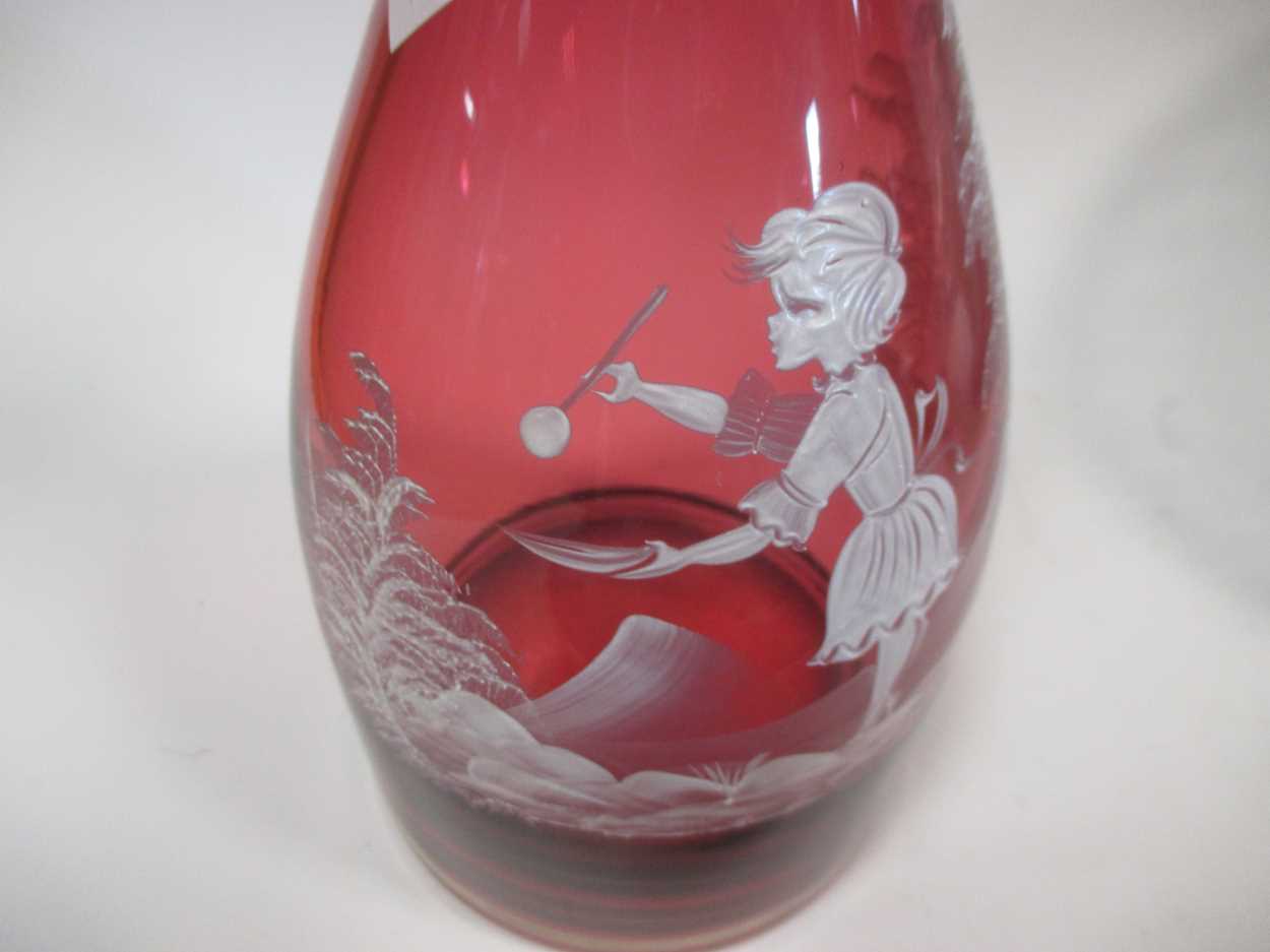 A pair of cranberry glass carafes painted with Mary Gregory style figures and a 'Marie Antoinette' - Image 7 of 7