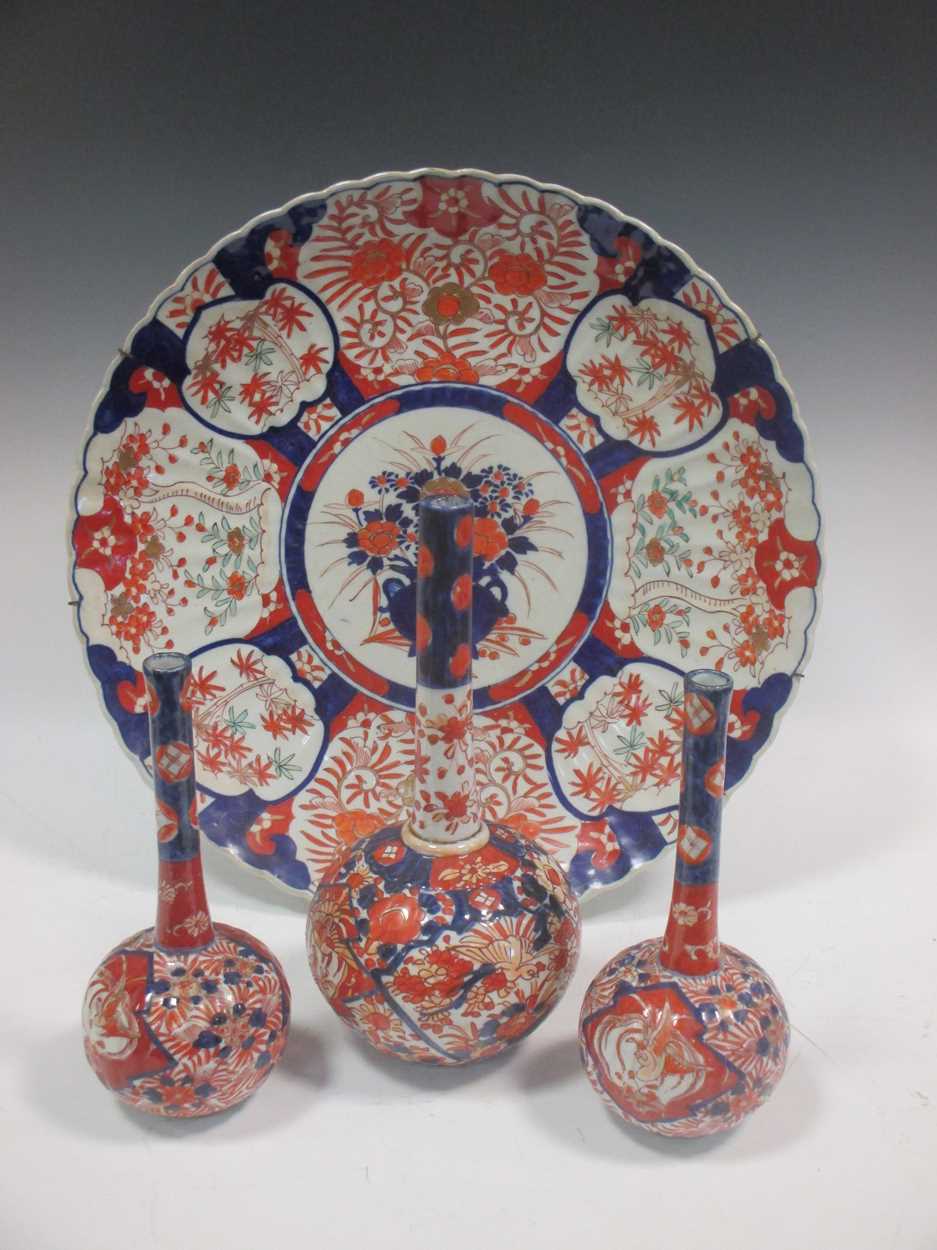 A large Japanese imari charger, 47cm diameter; three similar bottle vases (4)