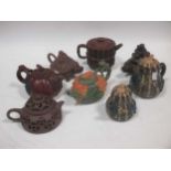 A group of eight Chinese Yixing and other teapots, in variously coloured clays, including those