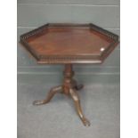 A Mahogany tripod table with gallery top on carved base, George III and later