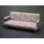 A Victorian sofa on turned legs and casters 170cm