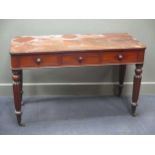 A 19th century mahogany side table, fitted with three drawers on fluted legs