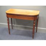 A 19th century D shape crossbanded rosewood card table, on gilt relief turned and tapered legs