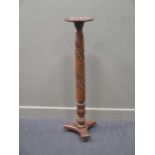 A mahogany carved torchere stand 123cm high