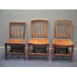 A pair of elm seated stick back chairs together with another chair (3)