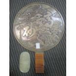 A polished metal hand mirror, probably Japanese, and a small hardstone carving