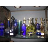 A pair of candlesticks cast with figures to the stems, various blue glass, pair of shaped decanters,