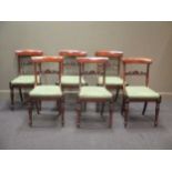 A set of Regency rosewood dining chairs, with plain concave top rail above a a carved horizontal