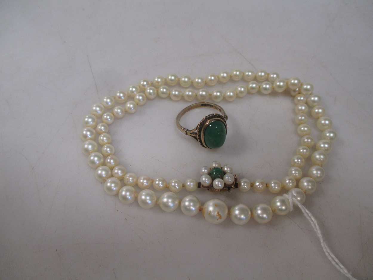 A row of cultured pearls together with a 9ct dress ring