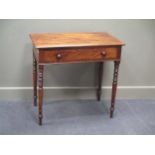 A late George III flame mahogany side table, the single frieze drawer over ring turned tapering legs