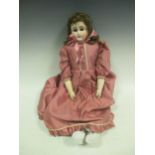 A French/German bisque head doll in later dress, early 20th century