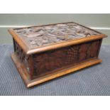 An oak table casket carved with fruiting vines 51cm wide