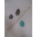 A string of cultured pearls. A Chinese turquoise gourd pendant. A Water polo and a swimming