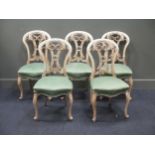 four painted chairs, with stuffed over cream fabric seats