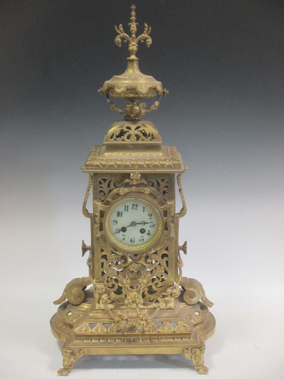 A large brass mantle clock, the white enamelled dial with Arabic numerals, 72cm high