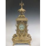 A large brass mantle clock, the white enamelled dial with Arabic numerals, 72cm high