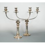 A pair of silver plated on copper three light candelabra with telescopic columns,