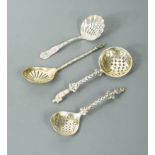 A collection of four Victorian silver novelty sugar sifting spoons,