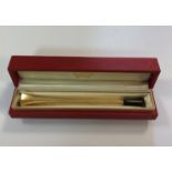 A cigarette holder marked '14K' and cased by Cartier,