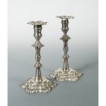 A pair of early George III silver cast candlesticks by Ebenezer Coker,