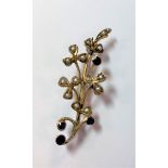 A sapphire and seed pearl floral brooch,