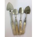 Two silver butter spades and two silver cheese scoops,