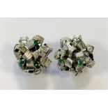 A pair of modern cluster eartsuds set with emeralds and diamonds,