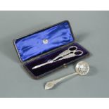 A cased pair of Victorian silver grape scissors and a sifting spoon, by George Unite,