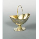 A Victorian silver gilt swing handled sugar basket,