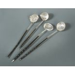 A collection of four punch ladles, one set with a Charles II coin,