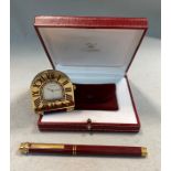 Cartier - A 'must de Cartier' travelling alarm clock and ballpoint pen,