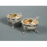 A pair of George IV silver cast salts and accompanying spoons,