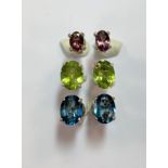 Three pairs of single stone earstuds - pink tourmaline, peridot and blue topaz,