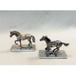 A pair of 20th Century cast silver models of horses,