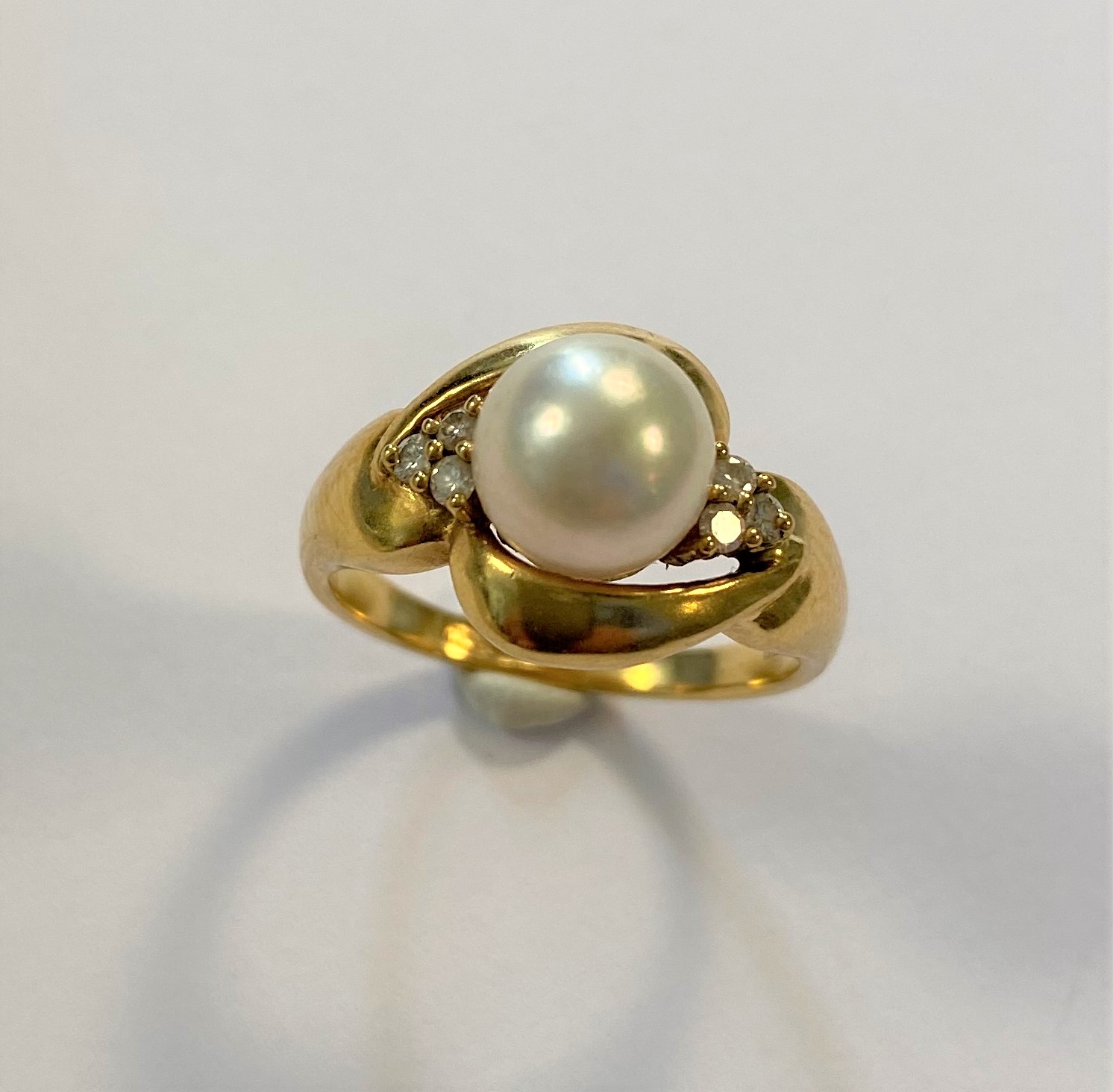 A modern style pearl and diamond ring,