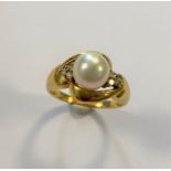 A modern style pearl and diamond ring,